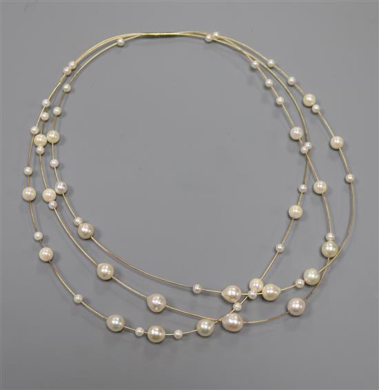 A modern 14ct and cultured pearl triple strand necklace, approx. 34cm.